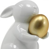 Coniglio con uovo dorato in ceramica, decoro pasquale elegante bianco, dorato H15cm