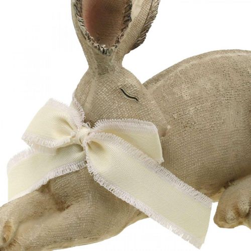 Floristik24 Coniglietto pasquale sdraiato con fiocco Decorazione pasquale in poliresina 28 cm