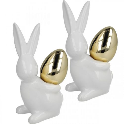 Prodotto Conigli con uovo d&#39;oro, conigli in ceramica per Pasqua bianco nobile, dorato H13cm 2pz